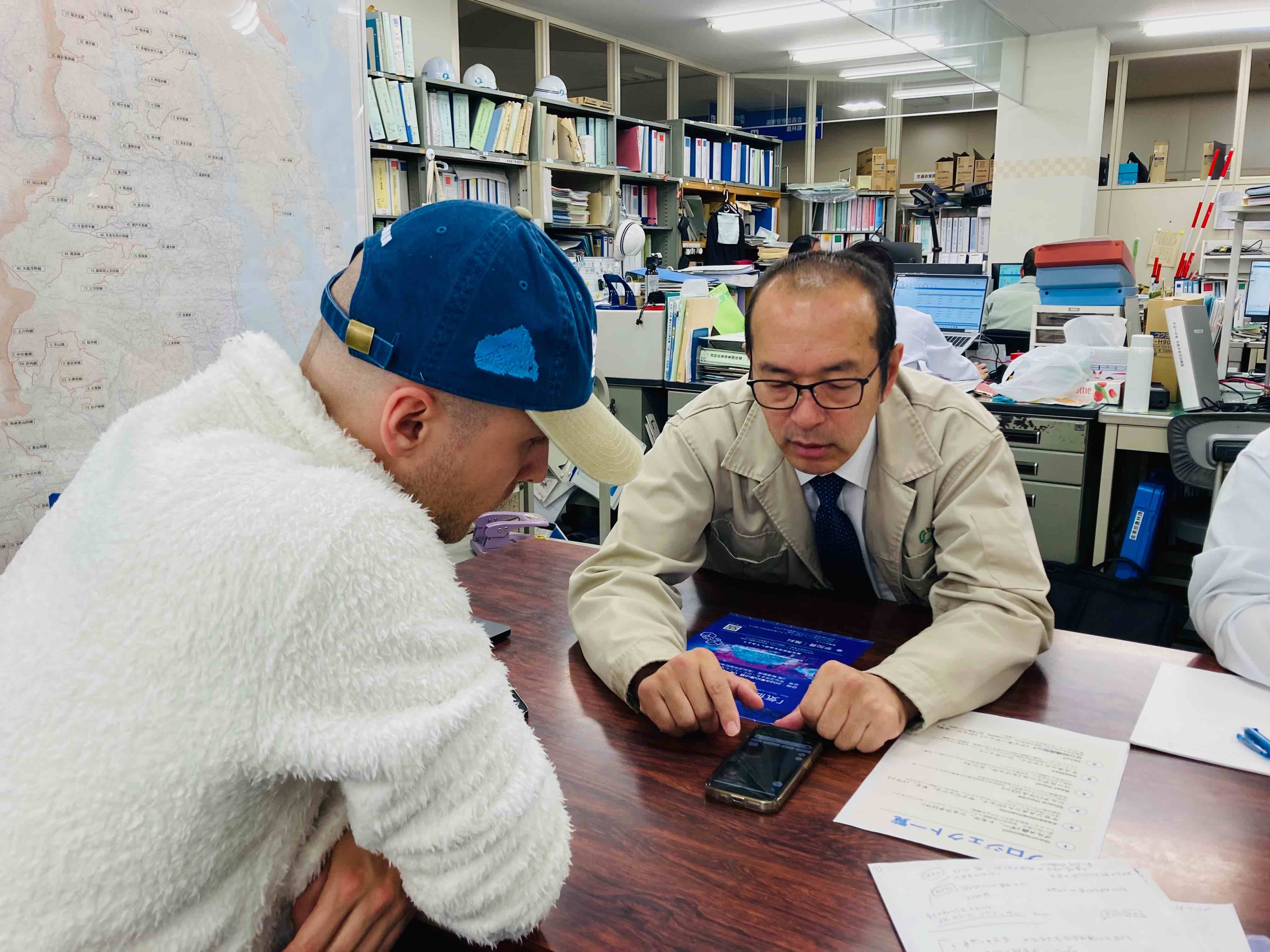 Developer and official reviewing solution on digital device